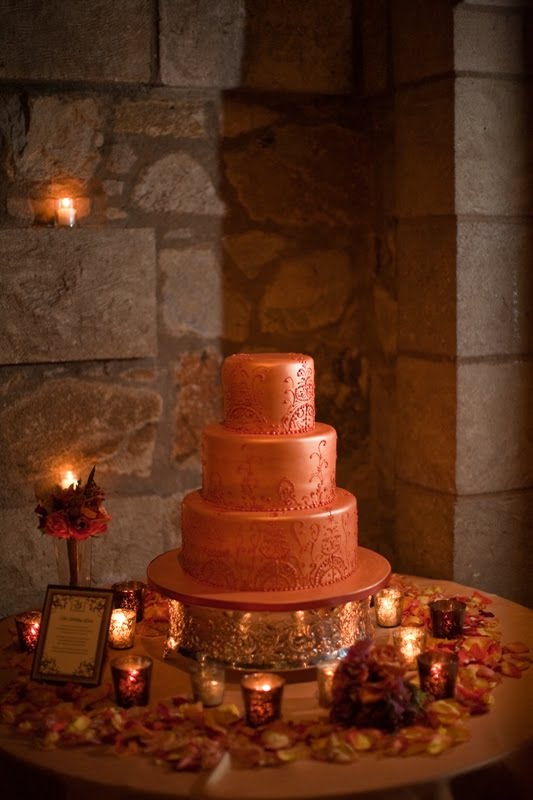 Gorgeous three tier patterned metallic orange wedding cake