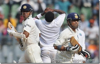 Indian batsman Sachin Tendulkar (R) and Rahul Dravid (L) run between the wickets as West Indies bowler Fidel Edwards (C) reacts during the third day play of the third Test cricket match between India and West Indies at t