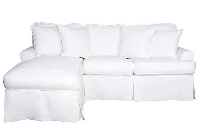 white slipcovered chaise and sleeper sofa combo