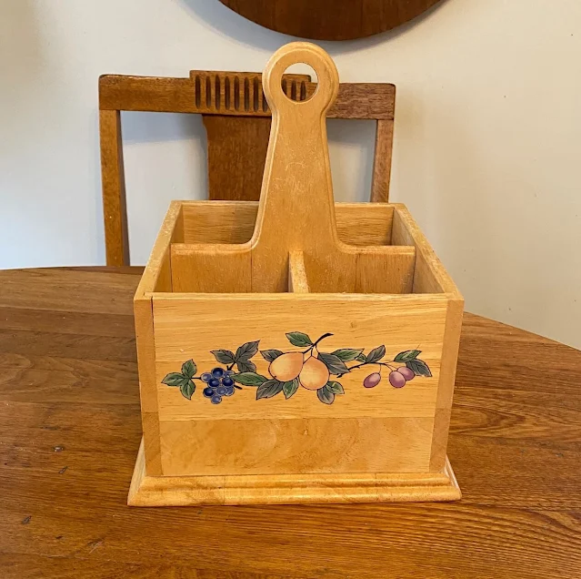 Photo of wooden silverware caddy.