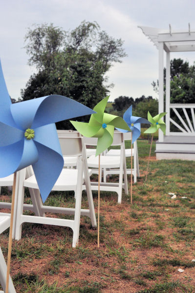 Alternating colors of pinwheels lined the aisle With the slight breeze 