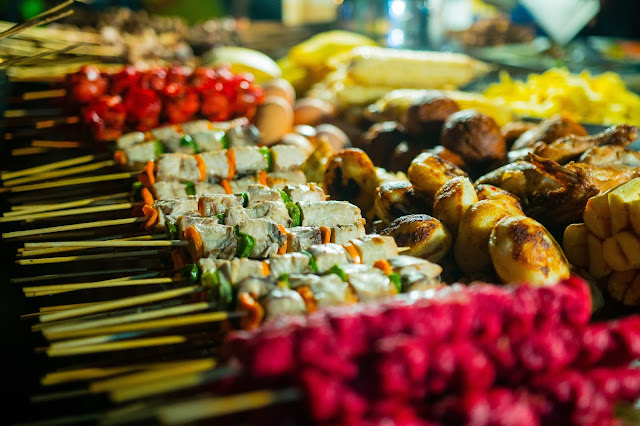 Street stall with a close up of the skewered food.