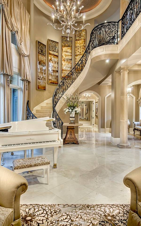 This luxury Foyer With Straight Staircase Leads Into The Two-Story