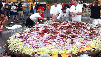  A Minnesota casino has cooked up a world-record bacon cheeseburger that's 3 metres in diameter and weighs more than a ton. The behemoth burger was served up on Sunday at the Black Bear Casino Resort near Carlton, Minnesota. Philip Robertson verified the record for biggest burger. It tipped the scales at 2,014lb, making it far larger than the previous record holder at 881lb 13oz. The monster patty took around four hours to cook using an outdoor oven. Black Bear’s burger included 60 pounds of bacon, 50 pounds of lettuce, 50 pounds of sliced onions, 40 pounds of pickles and 40 pounds of cheese.