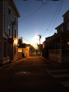 The last light of sunset down a small town Newport street.