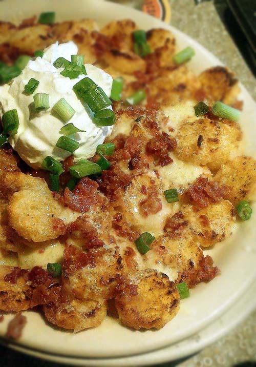 Loaded tater tots. Made using shredded cheese, crumbled bacon, chopped green onions and sour cream. Basic recipe can be used for loaded french fries, hash browns and other potato dishes.