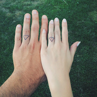 couples matching ring finger tattoos