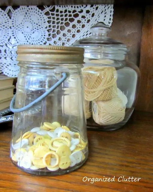 Photo of antique buttons in an antique jar.