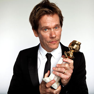 Kevin Bacon holding Golden Globe Award photo credit Casey Rodgers AP 