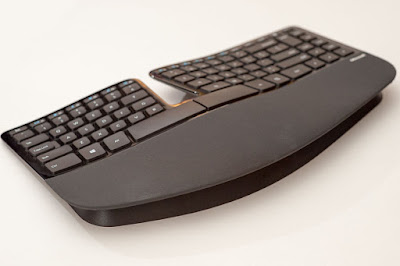 Microsoft Sculpted Ergonomic Keyboard- Left side view with keyboard foot engaged