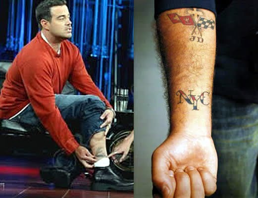  liber" on his left arm, plus an unknown tattoo design on his right leg.