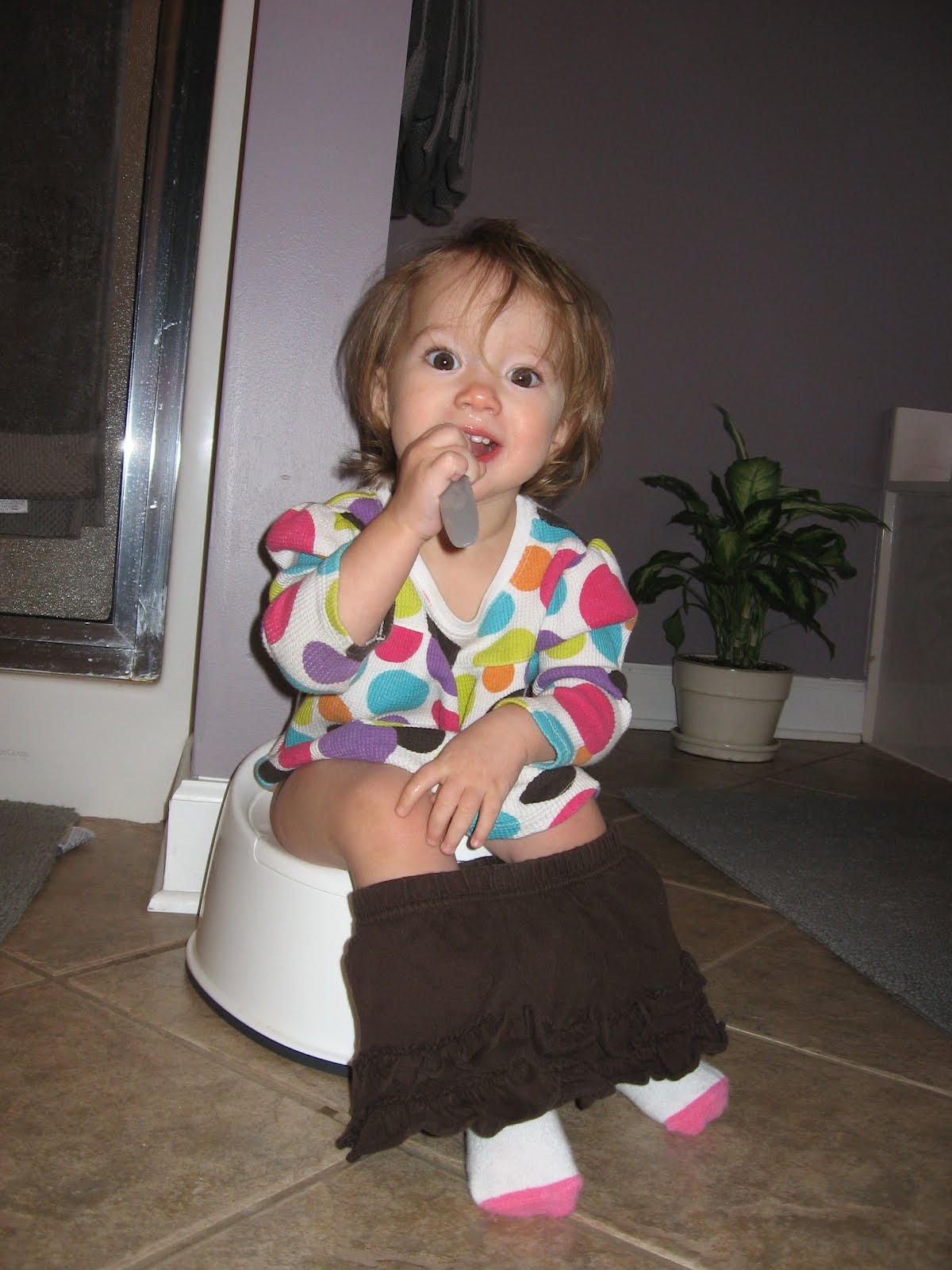  darling. Sitting on the potty and brushing her teeth. What a big girl