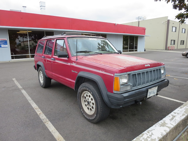 Rusty hood & peeling paint on Jeep Cherokee before repairs at Almost Everything Auto Body