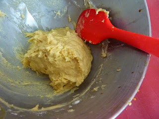 a ball of dough in a mixing bowl with a spatula