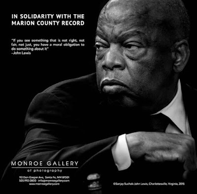 Ad featuring black and white portrait of Congressman John Lewis with text "In solidarity with the Marion County Record" and his quote "If you see something that is not right, not fair, not just, you have the moral obligation to do something about it"