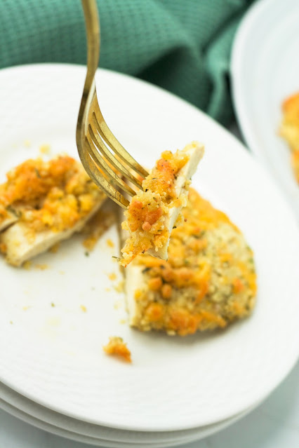 piece of chicken on a gold fork.