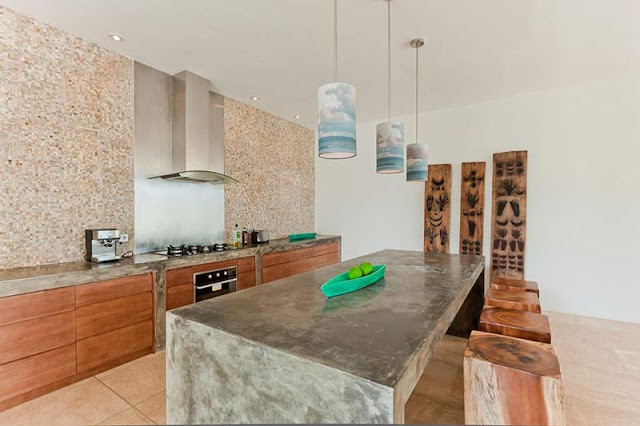 Picture of modern large kitchen with stone island in the middle and wooden chairs