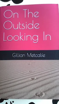 the pink front cover of my book on the outside looking in