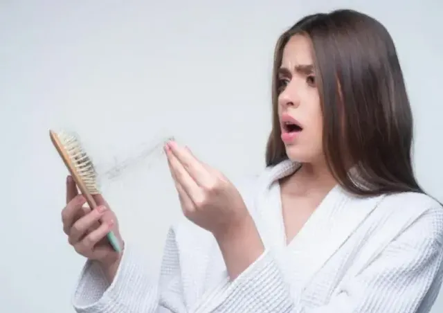 A woman worries about hair fall