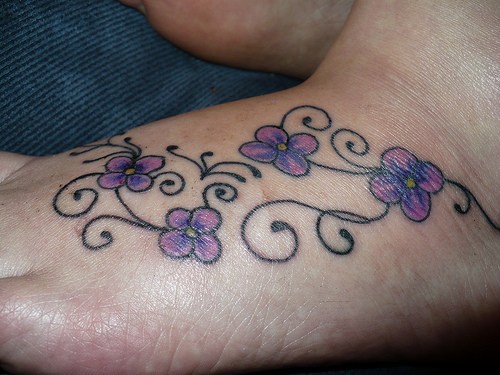 Girly flower tracery tattoo on foot