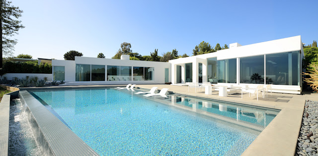 Modern home and swimming pool during the day 