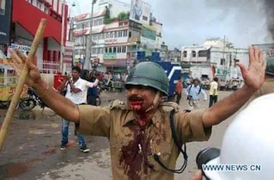 Policemen beaten down by stone pelters in kashmir for trying to maintain peace in islamist's war zone.