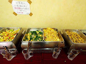 cooked vegetables in food warmers on display
