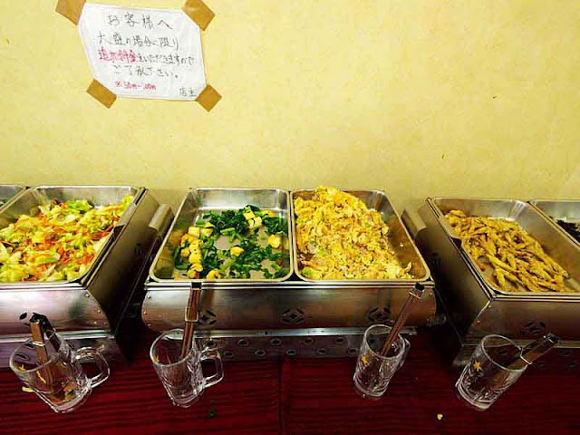 cooked vegetables in food warmers on display