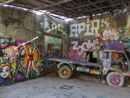 An abandoned vehicle and graffiti