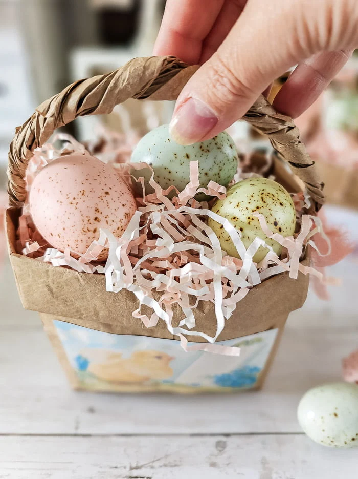 basket filled with crinkle paper, pastel eggs