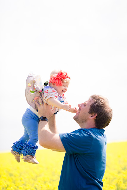 Family session including one-year cake smash in an Oklahoma canola field by Michelle Valantine Photography.