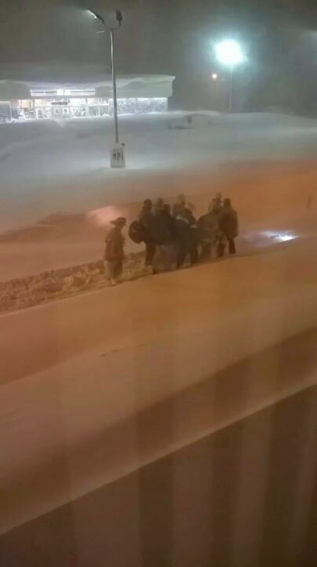 Emergency workers had to carry a patient to the hospital. - Unbelievable Photos From Upstate New York’s Freak Snowstorm.