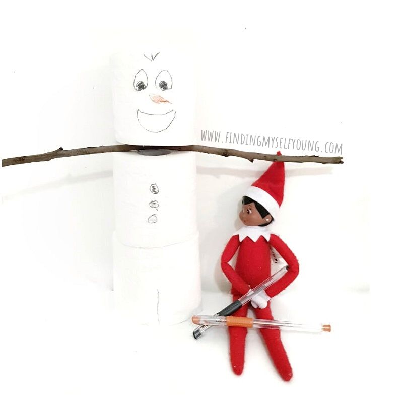 elf built a snowman from toilet paper rolls