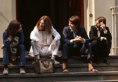 Beatles sitting on the steps from the Abbey Road photo-shoot