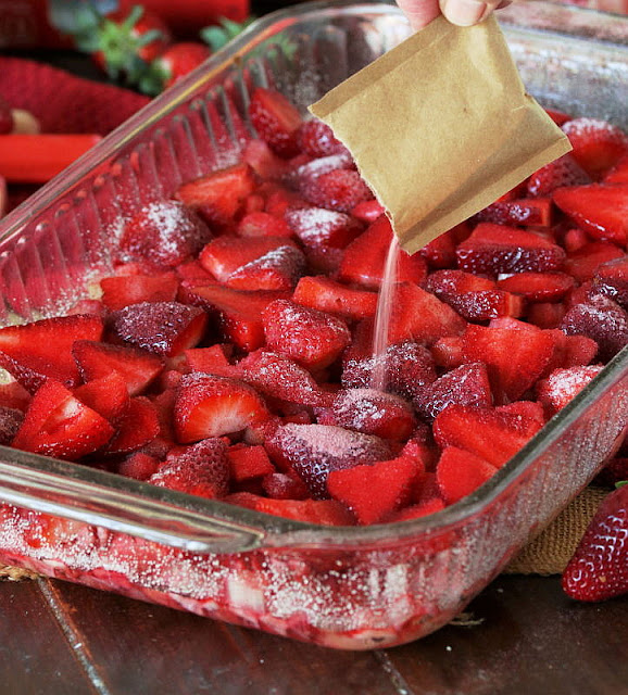 Sprinkling Sliced Strawberries with Strawberry Jello Powder Image