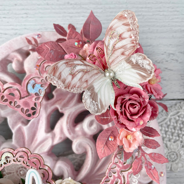 Beautiful Love Heart Mixed Media project created with: Reneabouquets butterflies, bubblegum pink roses, lace, heart chipboard frames, glitter glass; Spellbinders glimmer foil, anemone, autumn leaves, floral reflection; Tim Holtz distress victorian velvet; Pinkfresh jewels