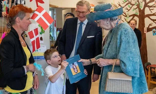 Princess Benedikte wore a black blazer and floral print skirt, and green cashmere cape. Princess Benedikte visited Old Frisian House