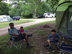 Family sitting outside tent