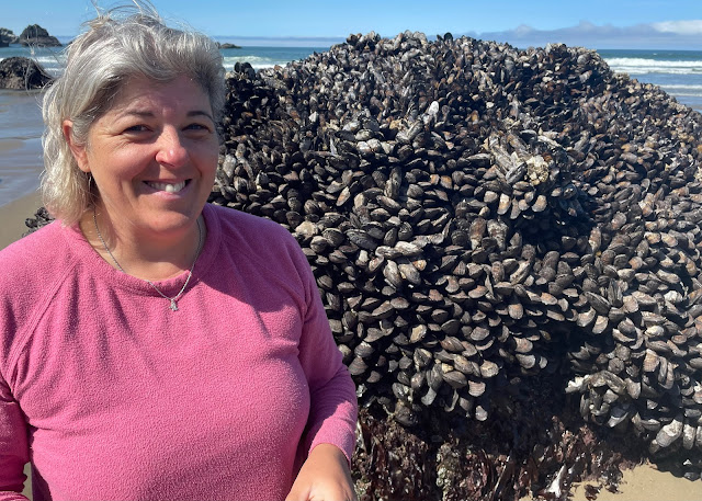 Me standing next to a rock covered with mussels on Indian Beach.