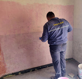 Halil painting primer on the walls
