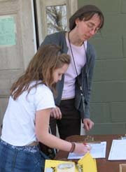 Maria-Bernadette helping Chloe Roe (Marta) to sign in for the day