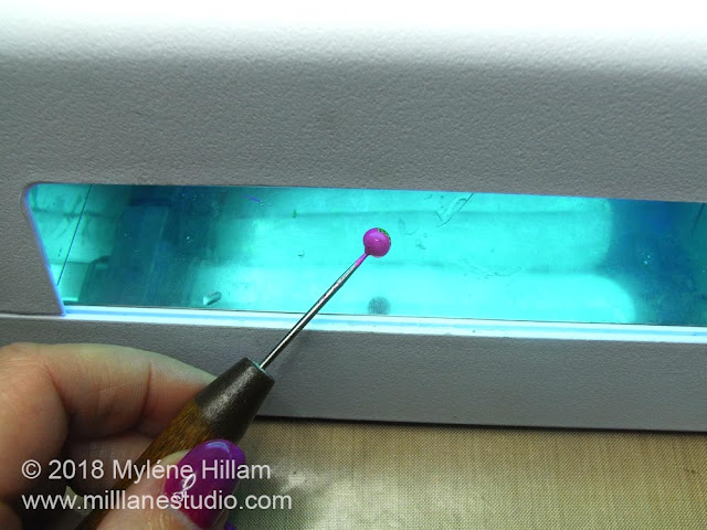 Curing the next layer of resin under the UV light.