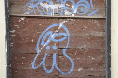 Graffiti image of a squid underneath unknown language from the old town centre of Genoa, Italy.