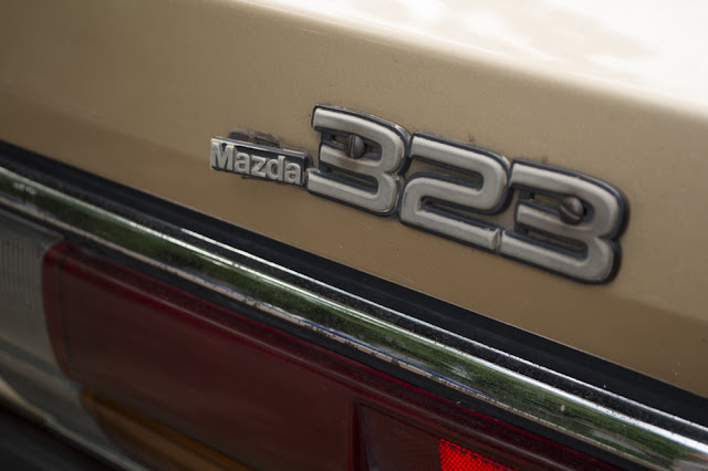 Gold 80's Mazda 323 logo