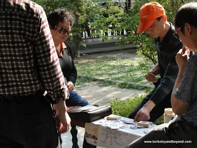 locals playing card game at Temple of Heaven in Beijing, China