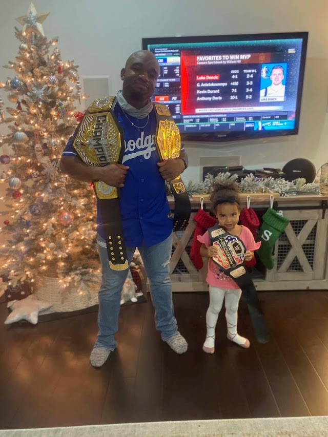 Nigerian Wrestler Display Daughter Holding WWE Heavyweight Belt