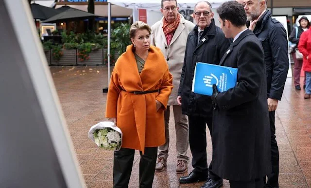 Grand Duchess Maria Teresa wore a Hooded orange cashmere coat by Dusan. Short open cashmere coat with hood