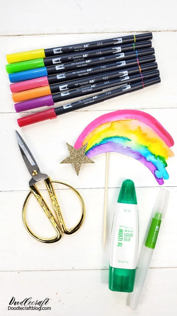 Supplies for Rainbow Cake Topper: Dual Brush Pens Watercolor Paper Scissors Gold Glitter Cardstock Star Shaped Punch Skewer Water Brush MONO Liquid Glue Tape