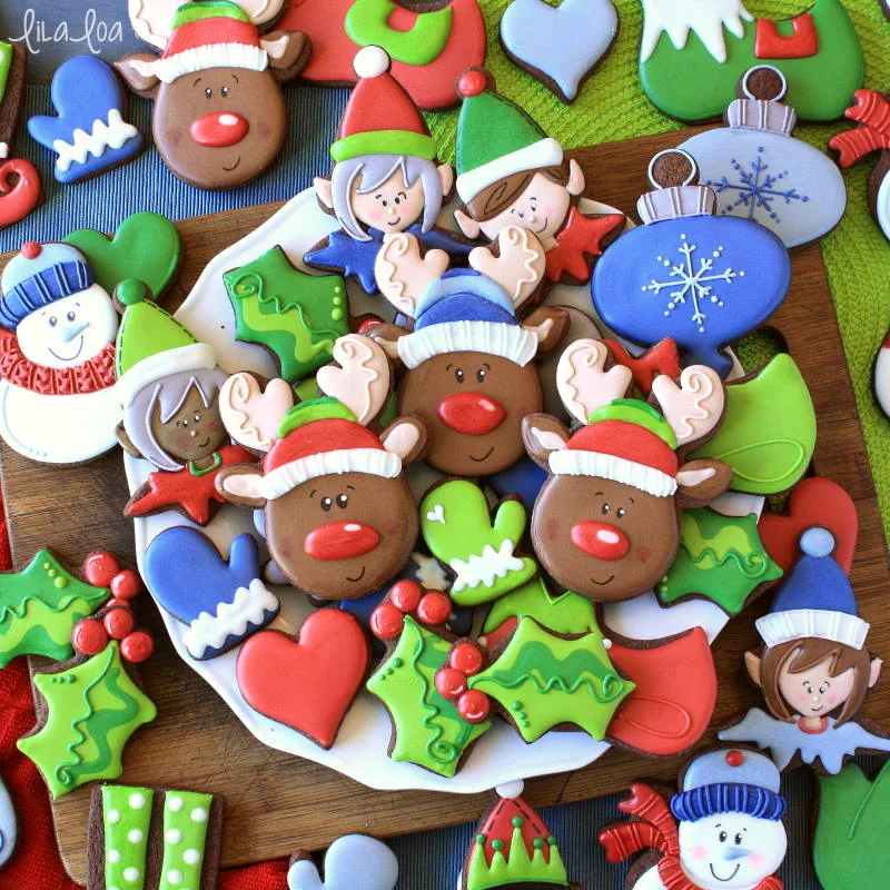 Brightly colored Christmas chocolate decorated sugar cookies -- reindeer, elves, holly