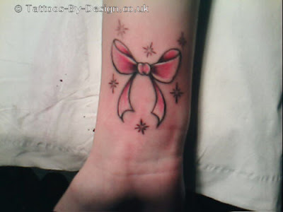 pink bow tattoo on wrist tattoos. bow tattoo is a cute tattoos for girls